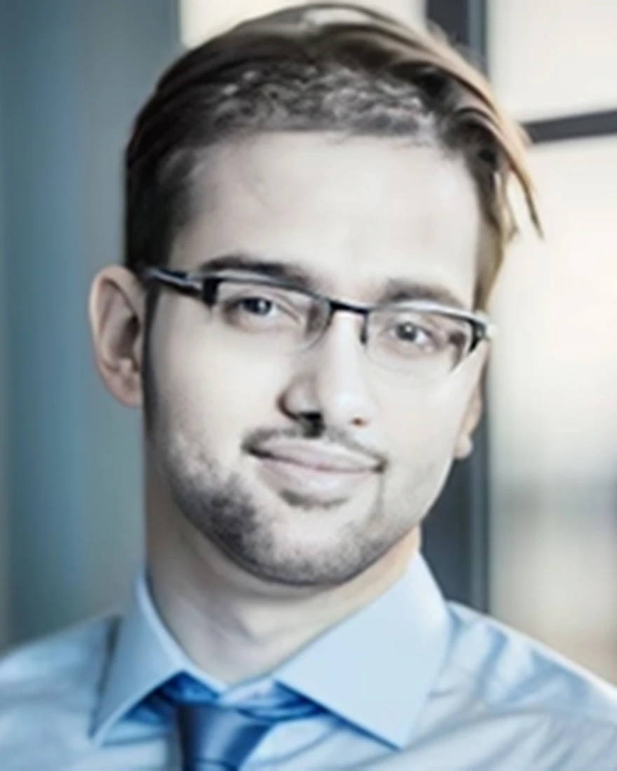 A man wearing glasses and a tie looks directly at the camera, representing Gourav Sharma's expertise in instructional design.